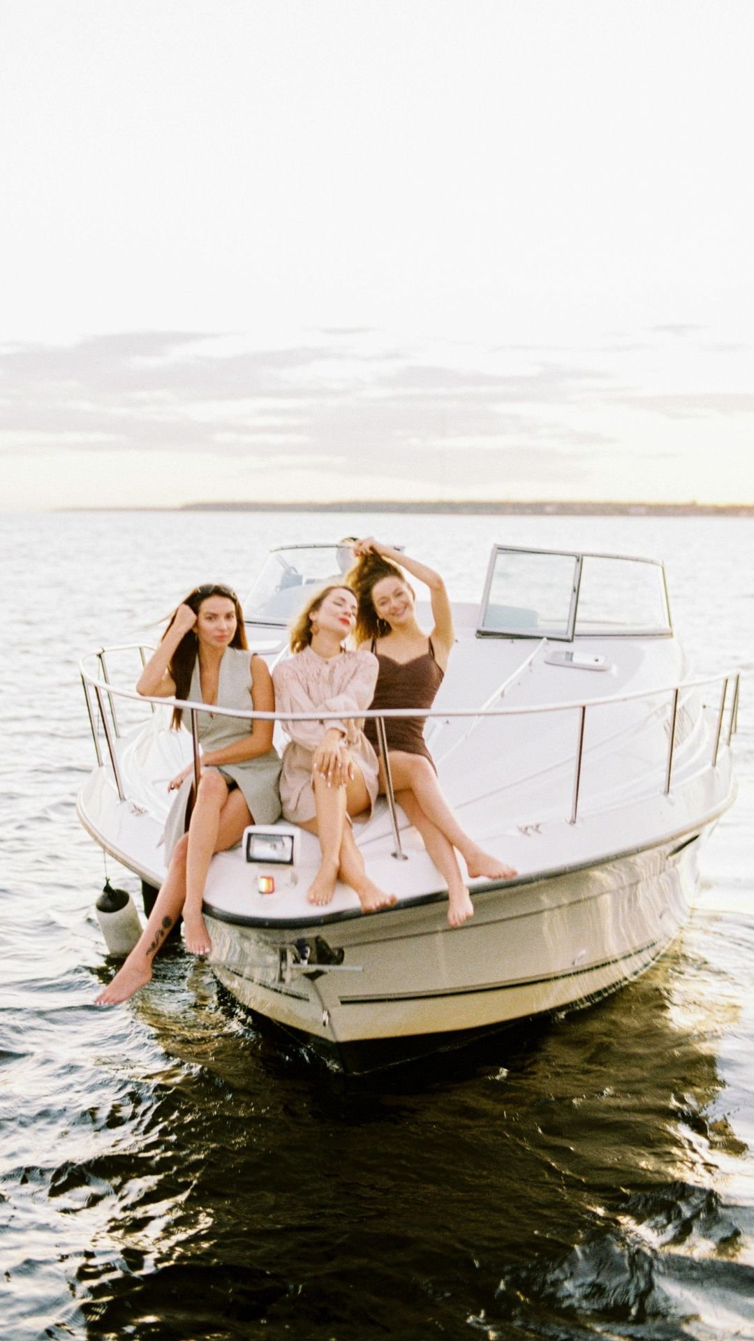 Friends enjoying golden hour on yacht
