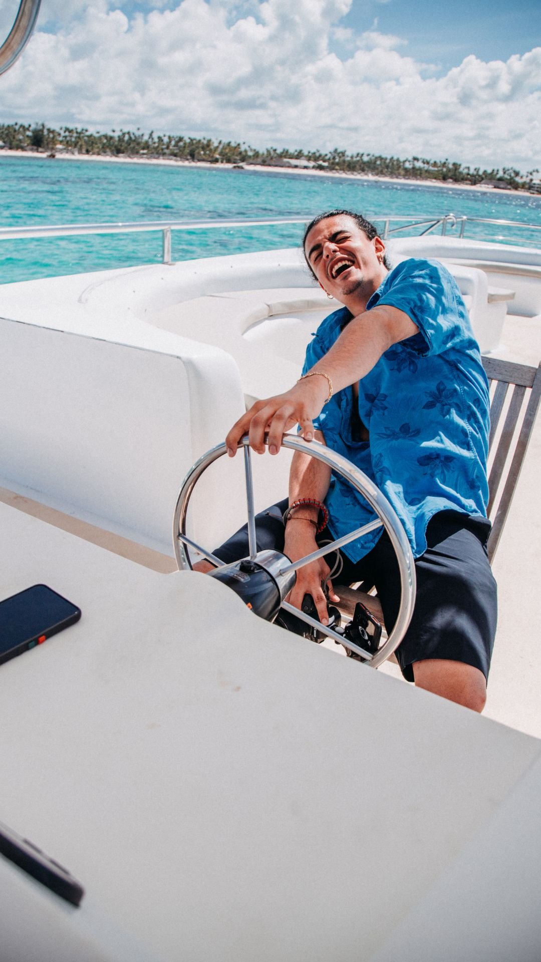 Enjoying the helm with turquoise Caribbean backdrop